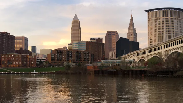 The Cleveland skyline and a stone arched bridge across the river in Ohio.