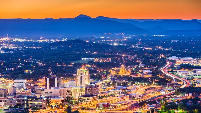City lights at dusk below a mountain ridge in Virginia.