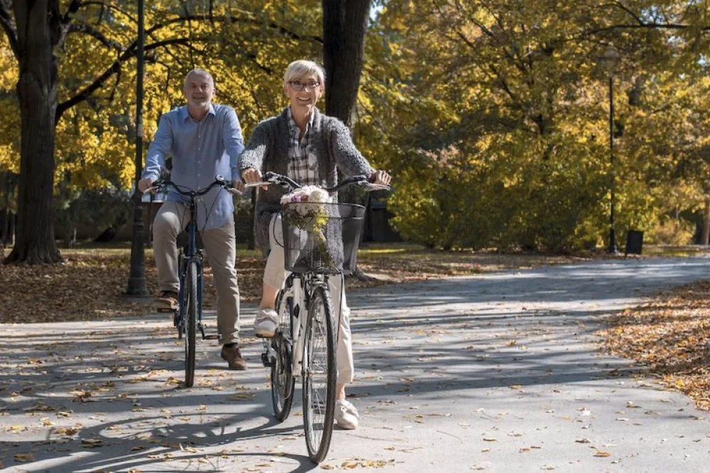 A beautiful picture of elderly riding bicycles in the park