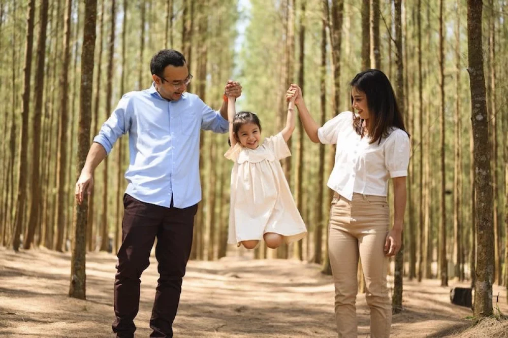Happy family travel in pine forest park