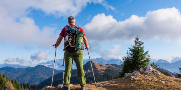 hiker with backpack is stand on mountain top